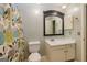 Clean bathroom with floral shower curtain and white vanity at 172 Twiggs Cor, Peachtree City, GA 30269