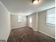 Spacious basement room with neutral walls and carpet, featuring multiple windows and exterior access at 4785 Kent Rd, Atlanta, GA 30337