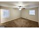 Spacious bedroom featuring ceiling fan, neutral walls, and carpet flooring at 2318 Emerald Falls Dr, Decatur, GA 30035