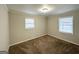 Bright bedroom with neutral walls, carpet flooring, and two windows with blinds at 2318 Emerald Falls Dr, Decatur, GA 30035