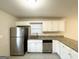 Galley kitchen with granite countertops and white cabinets at 2318 Emerald Falls Dr, Decatur, GA 30035