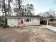 Newly renovated brick ranch house with red door and carport at 4303 Mercer Rd, Decatur, GA 30035