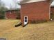 Brick side of house with basement access and yard at 5865 Ridge Se Dr, Mableton, GA 30126