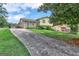 Two-story house with brick and siding, a sloping lawn, and a long driveway at 214 W Windemere Way, Jonesboro, GA 30238