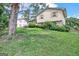 Two-story house with brick and siding, a sloping lawn, and large tree at 214 W Windemere Way, Jonesboro, GA 30238