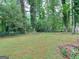 Private backyard with grassy area, surrounded by trees at 3031 Golden Dr, East Point, GA 30344