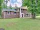 Brick house with a red door and well-manicured lawn at 3031 Golden Dr, East Point, GA 30344