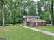 Two-story house with walkway, surrounded by lush green trees at 3031 Golden Dr, East Point, GA 30344