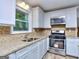 Modern kitchen with white cabinets and granite countertops at 3031 Golden Dr, East Point, GA 30344
