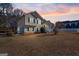 House exterior at dusk with attached garage and landscaping at 27 Estates Dr, Villa Rica, GA 30180