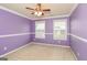 Charming bedroom with purple walls and ceiling fan at 5539 Halsey Trce, Atlanta, GA 30349