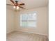 Spacious bedroom with large window and ceiling fan at 5539 Halsey Trce, Atlanta, GA 30349