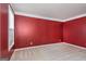 Red-walled bedroom with window and carpet flooring at 5539 Halsey Trce, Atlanta, GA 30349
