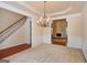 Formal dining room with chandelier and view of the living room at 5539 Halsey Trce, Atlanta, GA 30349