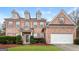 Brick two-story house with a large yard and a two-car garage at 5539 Halsey Trce, Atlanta, GA 30349