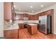 Kitchen with island, stainless steel appliances, and hardwood floors at 5539 Halsey Trce, Atlanta, GA 30349