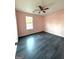 Bright bedroom with ceiling fan and grey laminate flooring at 3203 Pawnee Dr, Rex, GA 30273