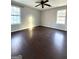 Large bedroom with hardwood floors and two windows at 3203 Pawnee Dr, Rex, GA 30273