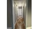 A long hallway with tile flooring and neutral walls at 3203 Pawnee Dr, Rex, GA 30273