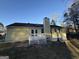 Rear view of yellow house with deck and landscaping at 3203 Pawnee Dr, Rex, GA 30273