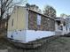 House exterior with stone and yellow vinyl siding at 3203 Pawnee Dr, Rex, GA 30273
