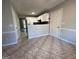 Kitchen features white cabinets, tile floors, and a breakfast bar at 3203 Pawnee Dr, Rex, GA 30273
