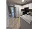 White kitchen cabinets, granite countertops, and tile floors at 3203 Pawnee Dr, Rex, GA 30273