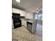 Modern kitchen with stainless steel appliances and tile floors at 3203 Pawnee Dr, Rex, GA 30273