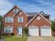 Brick house with 2-car garage, light blue shutters and landscaping at 1345 Pinebreeze Way, Marietta, GA 30062