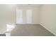 Bedroom showcases two white doors, neutral walls with trim, and neutral carpet providing a calming and serene retreat at 1129 Winston Dr, Decatur, GA 30032