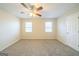 Spacious bedroom featuring neutral carpet, a ceiling fan, and two bright windows at 1129 Winston Dr, Decatur, GA 30032