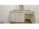 Bathroom vanity featuring granite countertops, white cabinets, a sink, and stylish fixtures, creating a modern and functional space at 1129 Winston Dr, Decatur, GA 30032