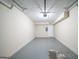 A clean, unfinished garage with a door leading outside and white walls at 1129 Winston Dr, Decatur, GA 30032