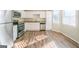 Bright kitchen with stainless steel appliances, white cabinets, and new hardwood floors at 1129 Winston Dr, Decatur, GA 30032