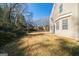 An expansive backyard with lush grass, mature trees, and the side of the home at 1129 Winston Dr, Decatur, GA 30032