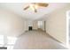 Spacious living room with neutral carpet, ceiling fan, and fireplace at 1129 Winston Dr, Decatur, GA 30032