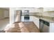 Modern kitchen featuring stainless steel appliances, granite countertops, and new hardwood floors at 1129 Winston Dr, Decatur, GA 30032