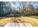 A spacious backyard filled with trees and a clearing covered in grass and sunlight at 1129 Winston Dr, Decatur, GA 30032