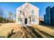 The backyard of the home with green grass, mature trees, and the exterior of the home at 1129 Winston Dr, Decatur, GA 30032
