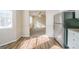 Kitchen with stainless steel refrigerator and new hardwood floors, opening to a carpeted living room at 1129 Winston Dr, Decatur, GA 30032