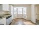 Eat-in kitchen featuring stainless steel dishwasher, granite countertops, and bright windows at 1129 Winston Dr, Decatur, GA 30032
