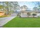 Ranch style home with gray exterior, landscaped lawn, and driveway at 1884 Derrill Dr, Decatur, GA 30032