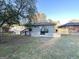 Gray brick house back with a deck, stairs, and a small yard at 1884 Derrill Dr, Decatur, GA 30032