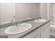 Bathroom featuring a double sink vanity, a neutral countertop, and a large mirror at 12029 Conrad Circle, Hampton, GA 30228