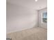 This bedroom features neutral carpet, white walls, baseboard trim, and a window at 12029 Conrad Circle, Hampton, GA 30228