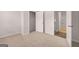 Bright bedroom featuring a carpeted floor, white walls, and an open door to a bathroom at 12029 Conrad Circle, Hampton, GA 30228