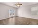 Bedroom with wood flooring, ceiling fan and sliding glass door for natural light at 12029 Conrad Circle, Hampton, GA 30228