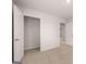This bedroom features neutral carpet, gray walls, an open closet, and a white door at 12029 Conrad Circle, Hampton, GA 30228