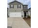 Charming two-story home featuring a two-car garage and a welcoming front porch at 12029 Conrad Circle, Hampton, GA 30228
