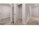 Hallway featuring neutral carpet, gray walls, a closet, white doors and white trim at 12029 Conrad Circle, Hampton, GA 30228